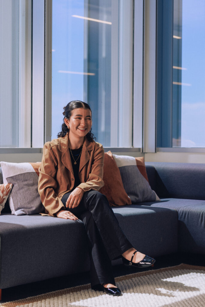 A smiling woman sitting on a couch named Stephanie